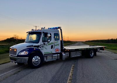 freightliner with century towing recovery flat deck