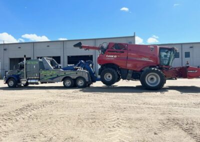 Tow truck pulling combine